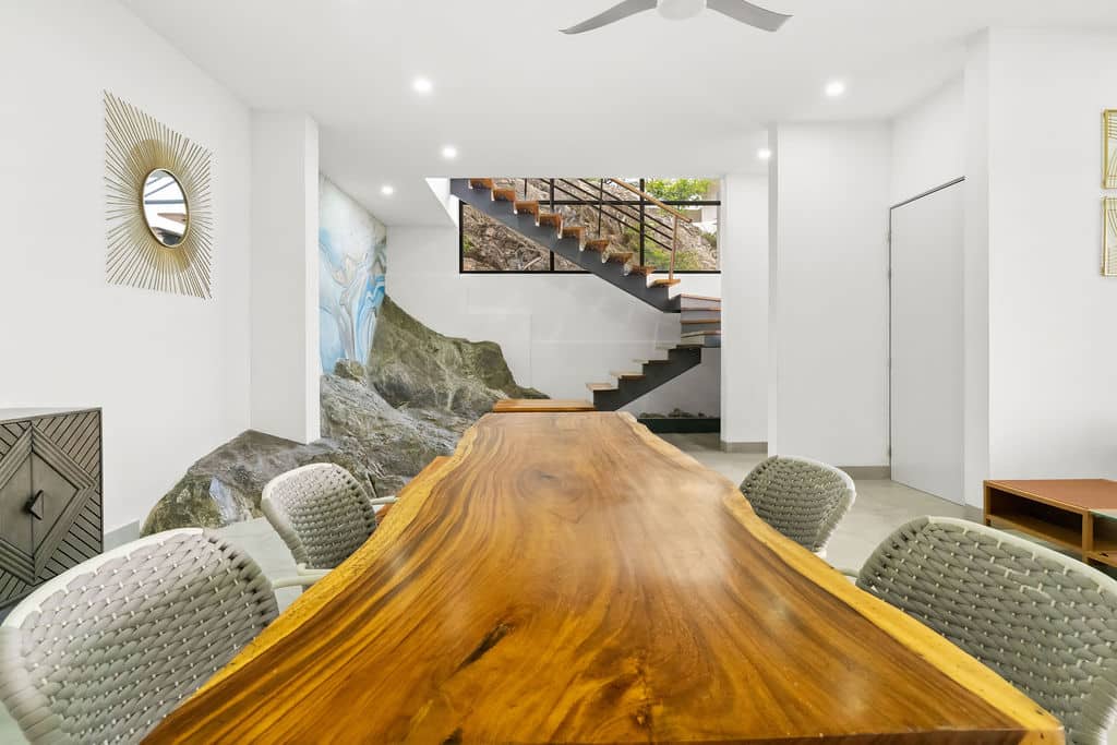 Live-Edge Guanacaste Wood Dining Table & Natural Rock Wall