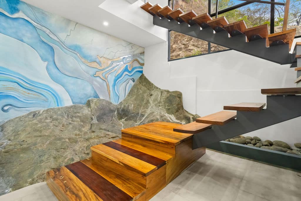 Natural rock formation inside Casa Roca with floating wood staircase